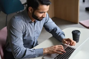 Municipal employee in office working on laptop.