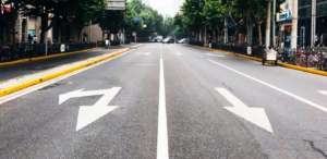 Close up of city road with painted lines and arrows.