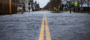 View down the middle of a flooded city street.