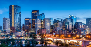 Calgary skyline at night with Bow River and Centre Street Bridge.