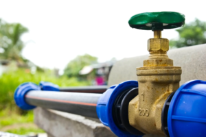 Close up of metal water pipes with faucet.