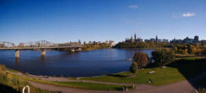 Drone view of city skyline and bridge.