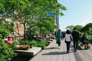 People relaxing on the High Line, a linear park created on an elevated section of a disused New York Central Railroad in New York city.