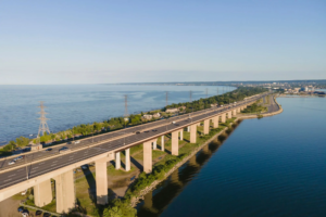 Aerial panorama of a QEW highway and Skyway Bridge connecting Burlington and Hamilton, Ontario, Canada.