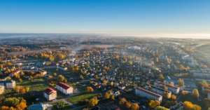 Drone view of a small town in countryside at sunset.