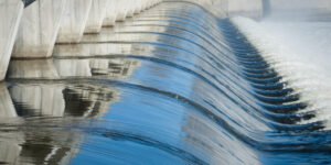 Close up of water flowing through a dam.