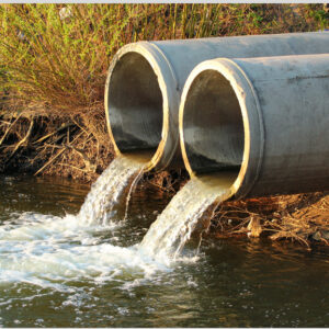 Water flowing out of 2 cement pipes into pond.