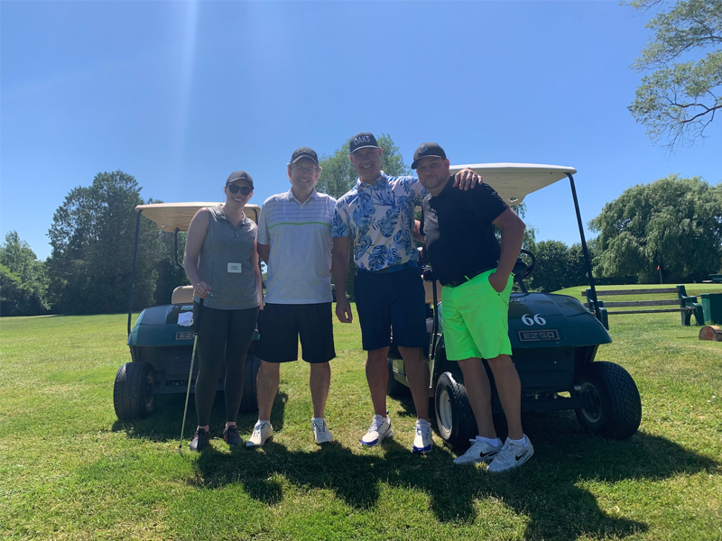 PSD Citywide staff and clients posing for a photo while on a golf course.