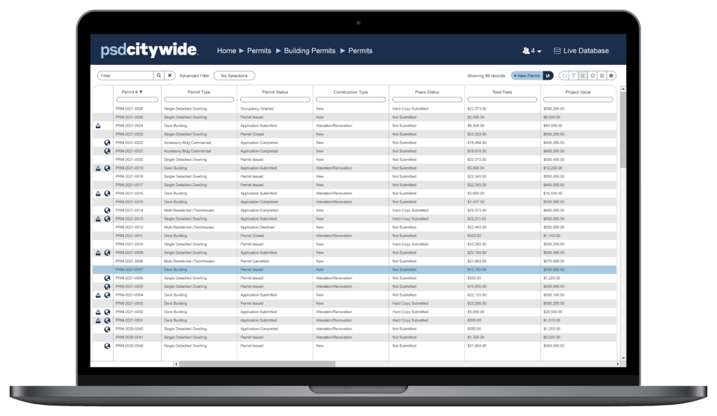 Laptop with Citywide Permitting software on screen.