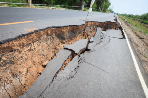 Collapsed pavement on country road.