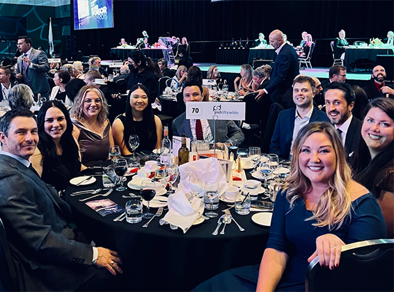 PSD Citywide staff smiling at a table during the London Chamber of Commerce gala.