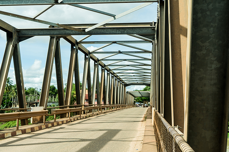 Concrete and metal bridge on sunny day.