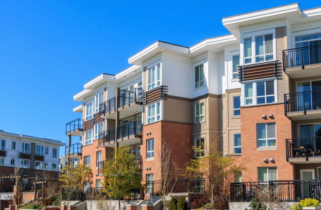 An apartment building with a blue sky in the background.