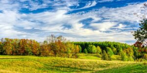 Panoramic view of pasture and forested hills in Wingham, Huron County, Ontario, Canada.