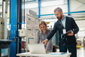 Facility managers analyze EAM trends dashboard to spot energy-wasting assets in an industrial plant.