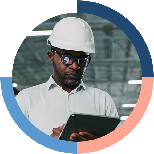 Facility manager using a tablet to access facility management software for municipalities or a public sector CMMS in an industrial setting.